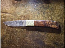 Damascus blade, curley walnut handle, brass bolsters with floral engraving